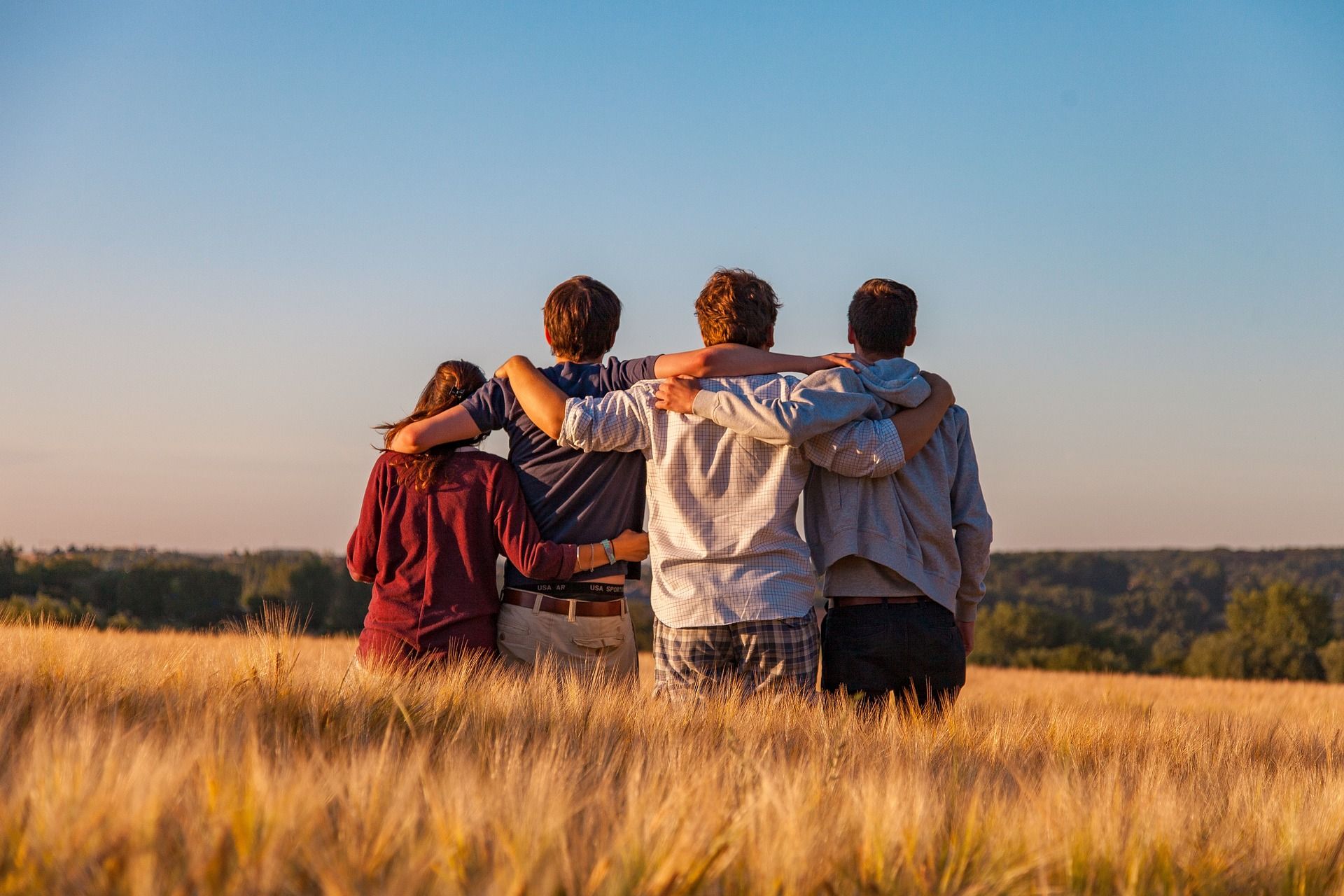 A family walking together through a golden field